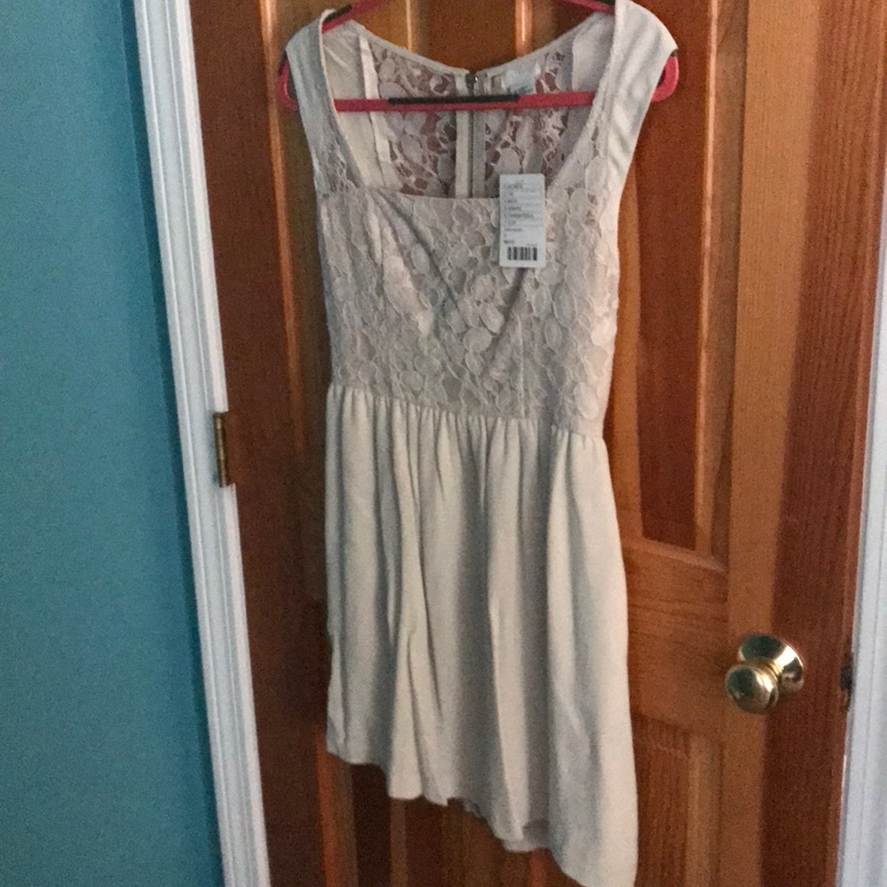Cream colored sleeveless dress.